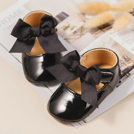 Patent booties with a bow