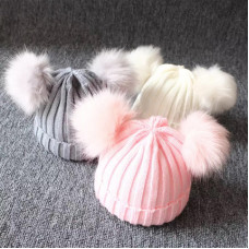 Hat with fluffy pompoms